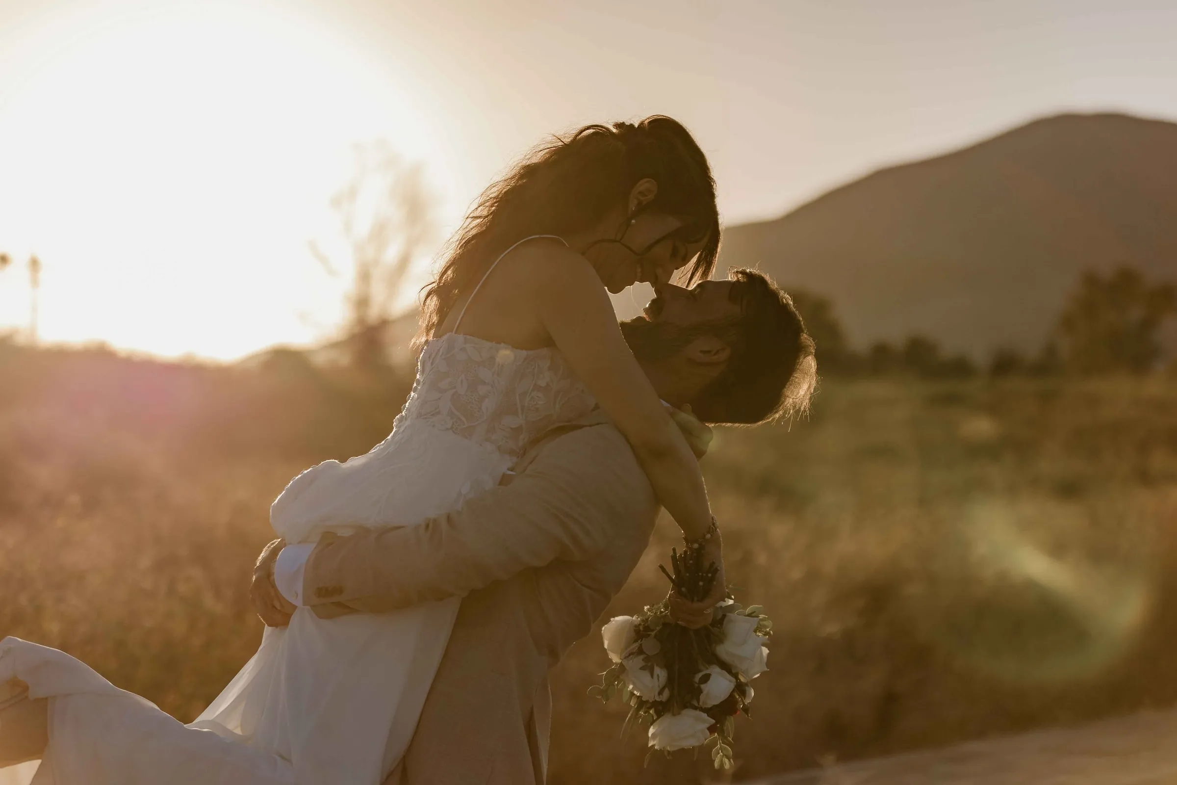 Couple embracing at sunset in the hills, destination wedding in Mijas