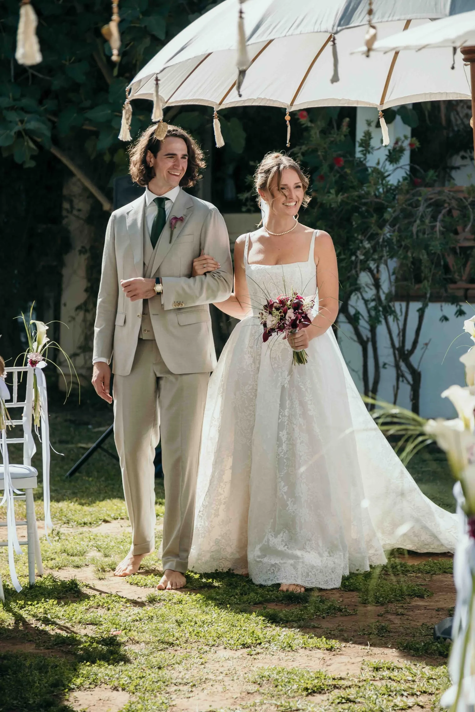 Bride and groom walking into their outdoor reception, wedding in Málaga